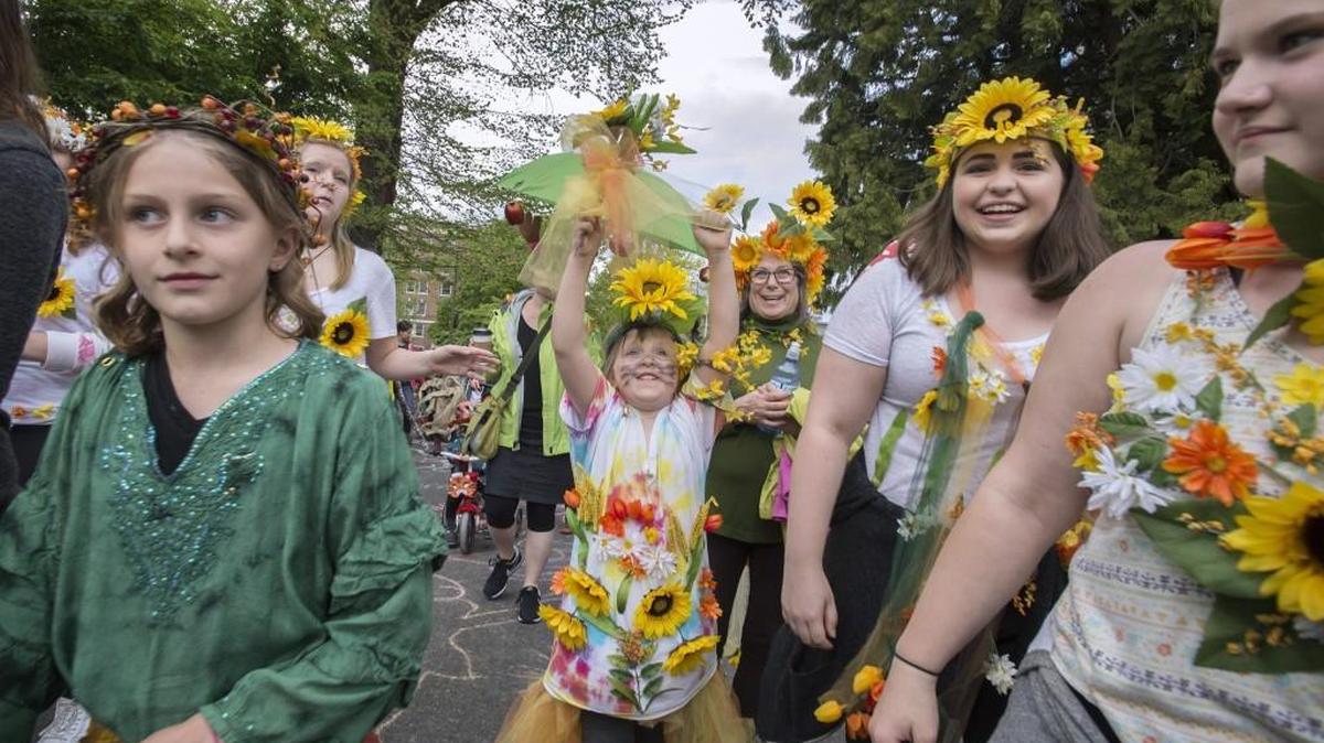 Samantha Reeves (center) lets her pedals bloom as she marches with family and friends during the Procession of the Species celebration in downtown Olympia on Saturday, April 23, 2016. This year’s event is 4:30 p.m. Saturday.