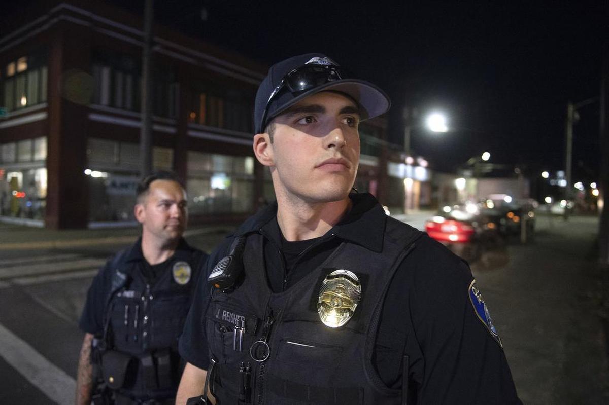 Olympia police officers Jordan Reisher, right, and Jacob Theis on a nighttime walking patrol of downtown. Nighttime patrols returned in June thanks to the public safety levy that passed last year.