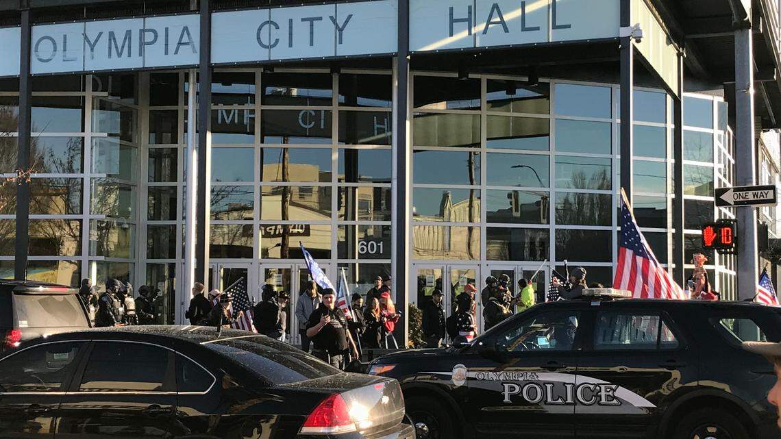 Armed Trump supporters in front of Olympia’s City Hall last Saturday. After a violent confrontation with counter-protestors near the state capitol, both groups marched through Olympia’s downtown.