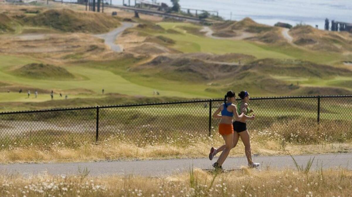 Runners jog along Grandview Trail through the North Meadow at Chambers Creek Regional Park in 2016. Parts of the park will be closed this week for a Tacoma Arts Live event.