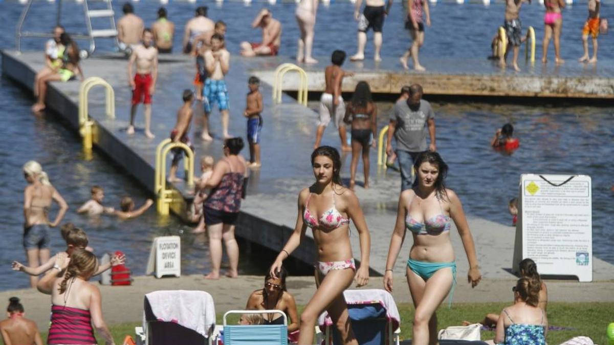 Swimmers and sun bathers fill the hillside at Long Lake Park in Lacey as temperatures climbed into the 80s on Thursday, July 10, 2014.