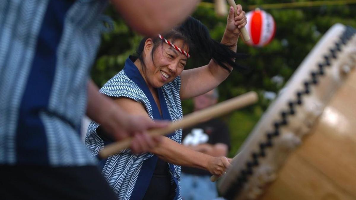 Karen Sakata of Seattle works up a frenzied beat with the Northwest Taiko Drummers to warm up the Bon Odori Festival audience. 