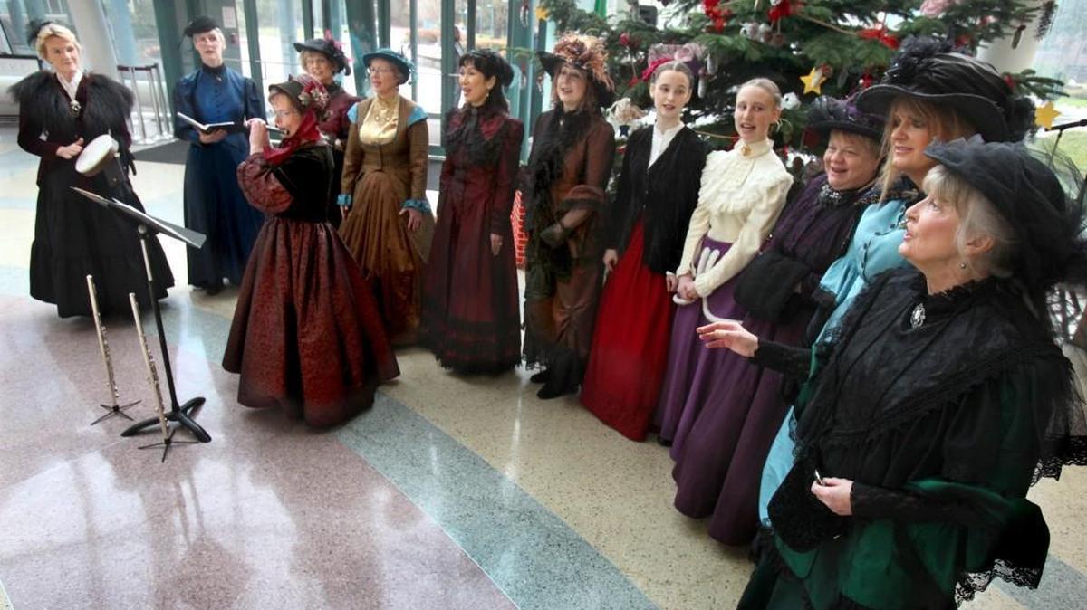 Resplendent in their period attire, the Joysong Victorian Carolers fill the atrium of the Department of Labor and Industries’ Tumwater headquarters with carols and hymns in December 2012.