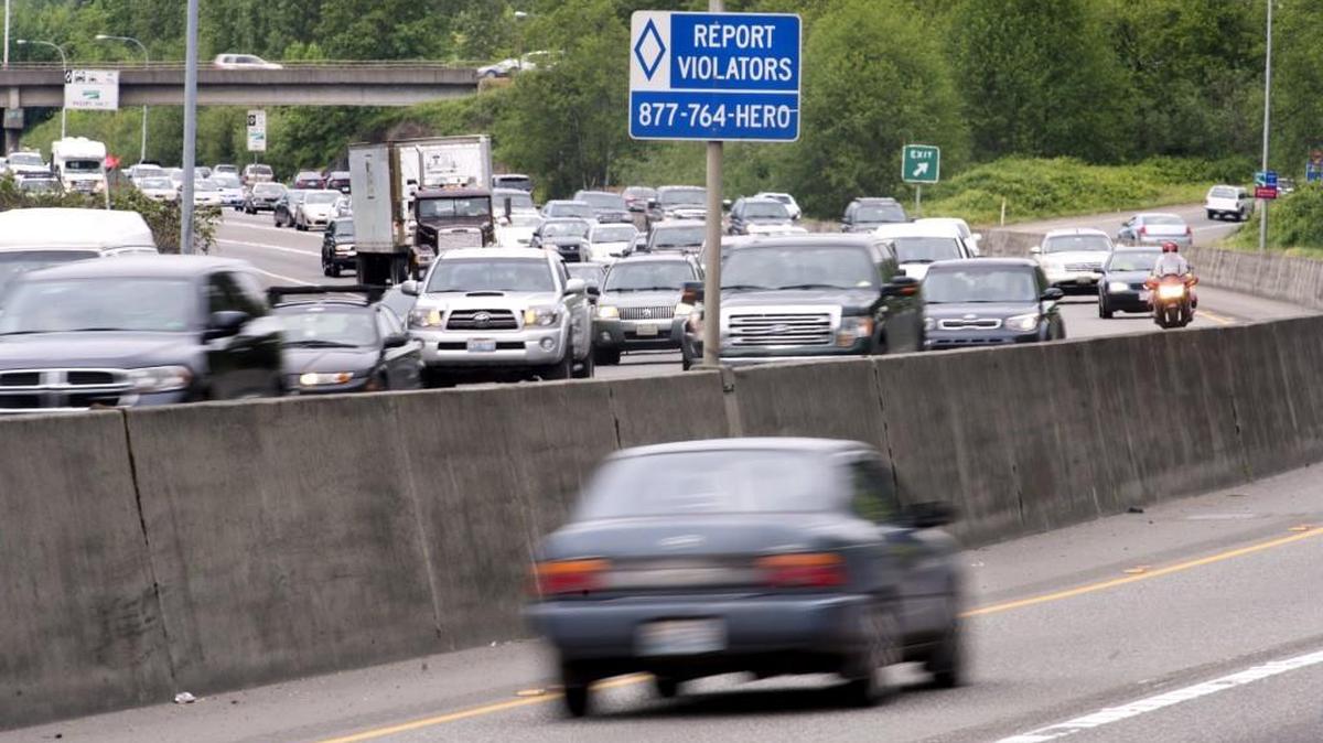 A Washington Department of Transportation sign on northbound state Route 167 in Kent, shown Thursday, encourages drivers to report HOV lane violators.
