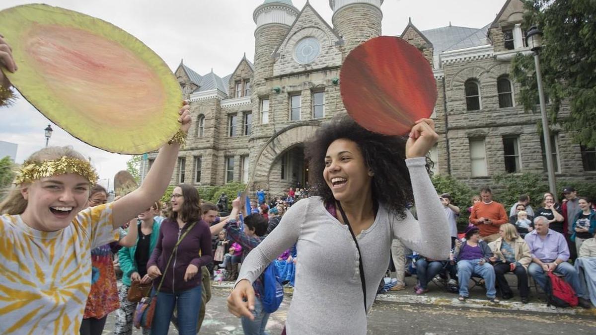 Anna Lee, left, and Laurel Mack-Wilson portray planets as they dance with friends during the 2016 Procession of the Species celebration in downtown Olympia. This year’s Procession is April 29.