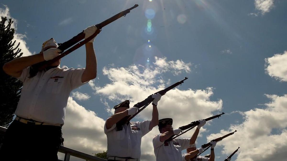 Members from the Ira L. Carter Post 318 of the Veterans of Foreign Wars fire a 21-gun salute at the conclusion of the annual waterside Memorial Day service Sunday at Percival Landing.