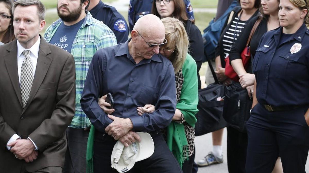 Lonnie and Sandy Phillips, center, whose daughter Jessica Ghawi was killed in the 2012 Aurora movie theatre attack, hold each other as they listen to District Attorney George Brauchler speak with members of the media following the reading of the jury's decision outside the Arapahoe County District Court in Centennial, Colo., Friday, Aug. 7, 2015. “Under the Gun,” airing Thursday In olympia explores gun violence in the United States. Special guests Lonnie and Sandy Phillips will speak after the film.