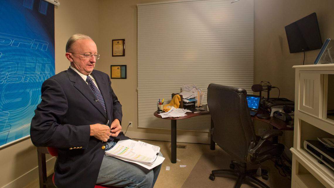 ESPN football commentator John Clayton gets ready to appear in his next ESPN segment in his home studio in Renton, November 20, 2013.