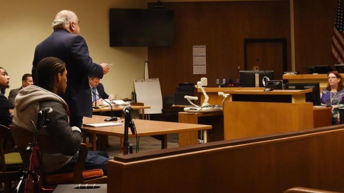 Flanked by defendants Andre Thompson (left) and Bryson Chaplin, defense attorney George Trejo addresses Thurston County Superior Court Judge Erik Price on Wednesday.