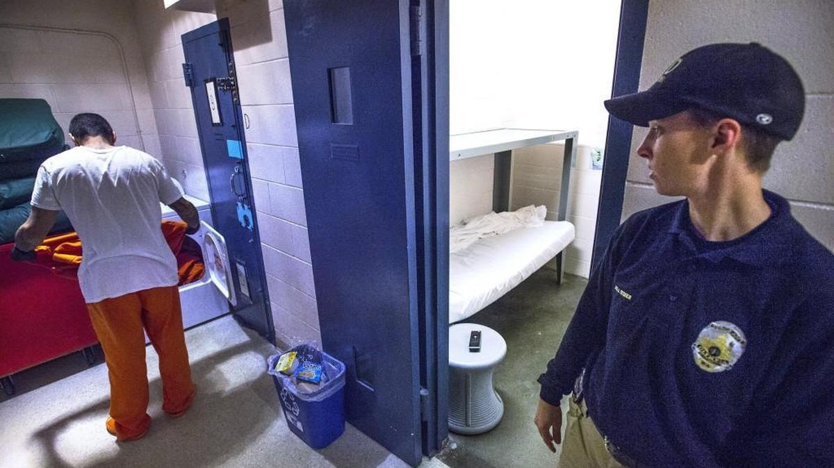Corrections officer Sgt. Jen Stiner keeps watch as a trusty inmate does laundry at the Olympia jail on Thursday.