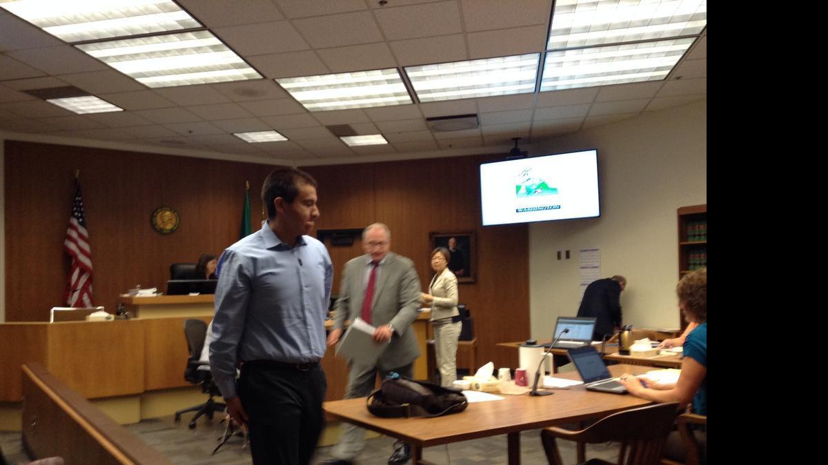 
William Thomas C. Frank III leaves a courtroom following his arraignment Tuesday, July 22, 2014, in Thurston County Superior Court. His trial in a related case, in which he is charged with theft, was delayed Wednesday until September.
