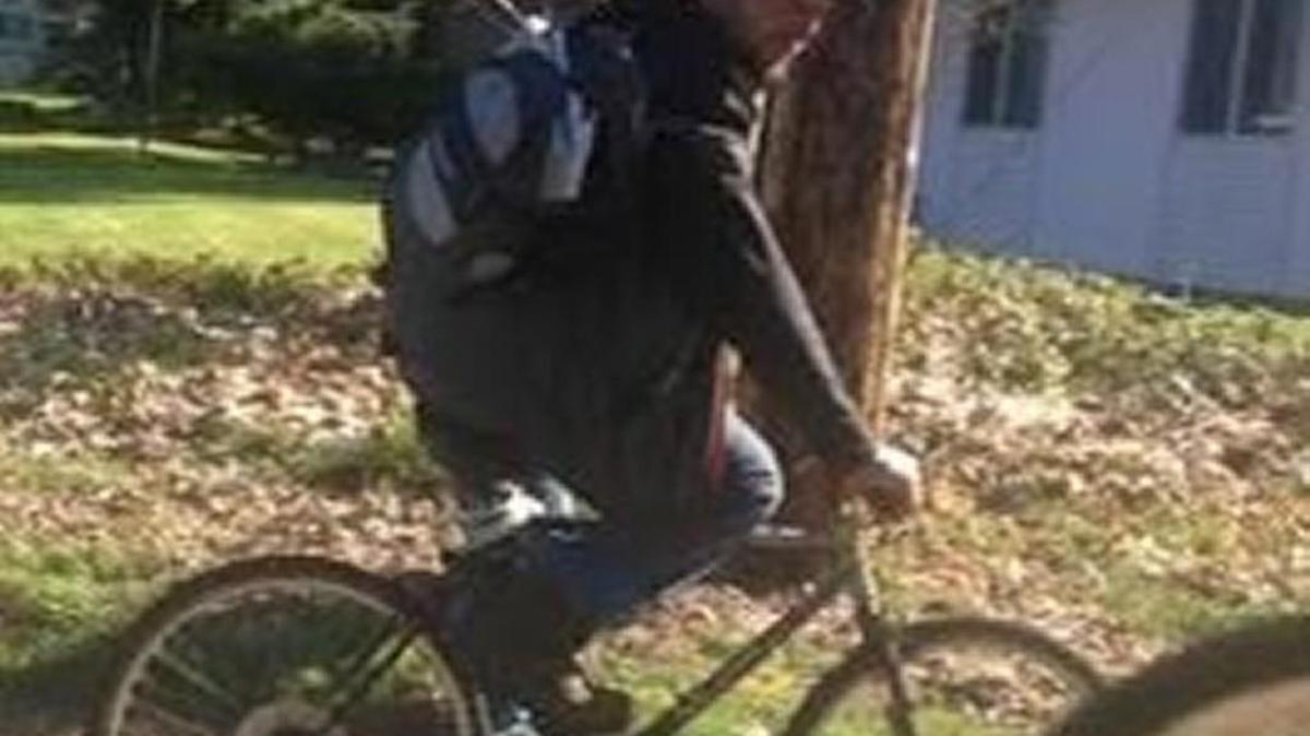 A suspect rides a bicycle a few blocks from where a car prowl occurred March 30 at Hand and Stone Massage and Facial Spa in Lacey.