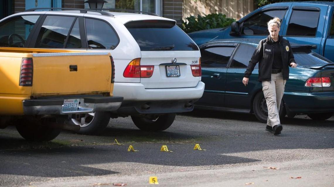 Shell casings are marked with numbered tags as police investigate the scene of a shooting on Forrestal Place Northeast in Lacey on Saturday.