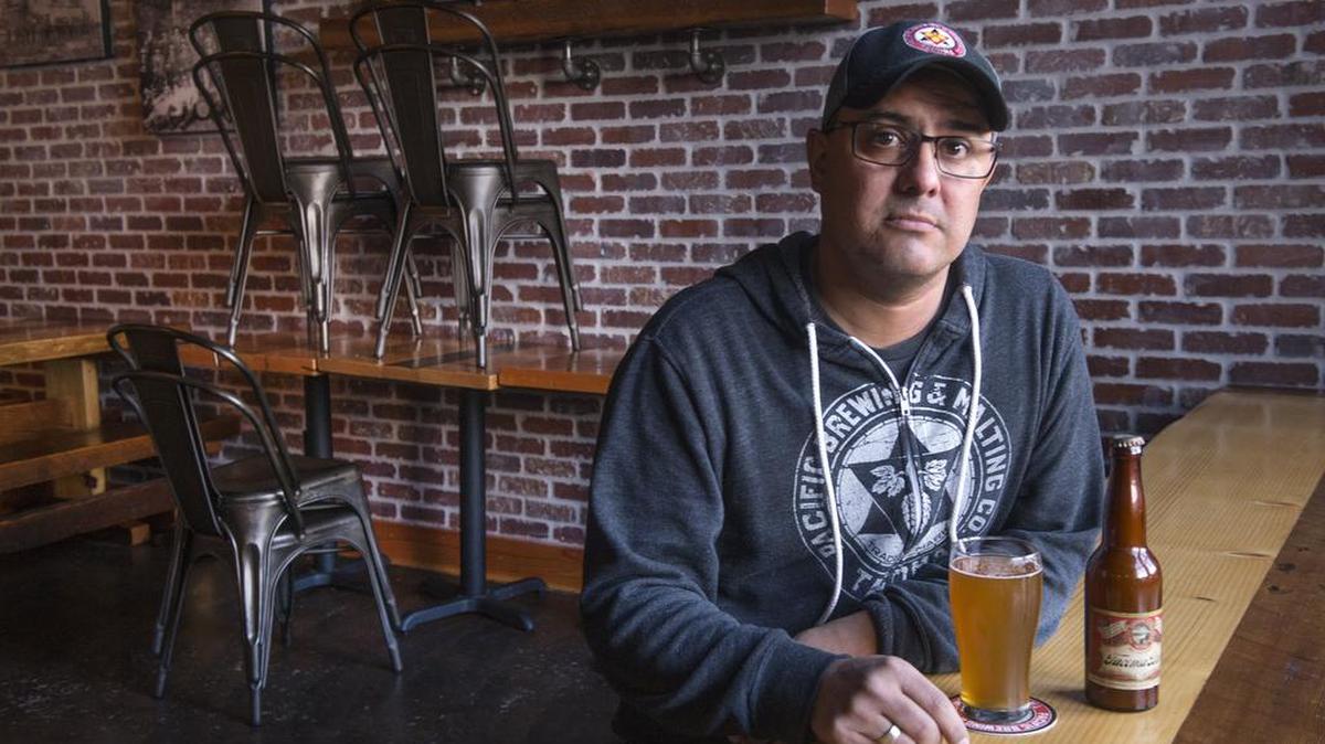 Steve Navarro, owner of Pacific Brewing and Malting, with a glass of his own brew and the only bottle of 100-year-old Tacoma brand beer that wasn’t stolen from his truck during a recent smash-and-grab robbery.