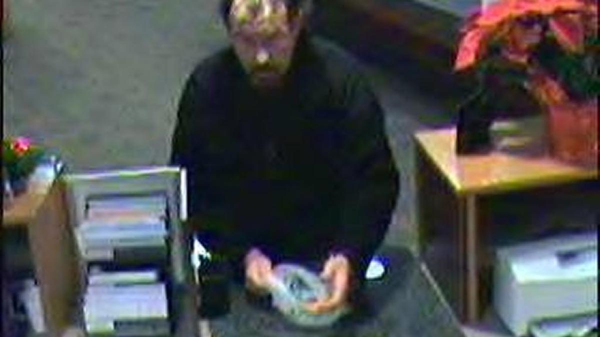 Security camera footage shows the man suspect of robbing Olympia Federal Savings, in Tumwater, on Friday night.