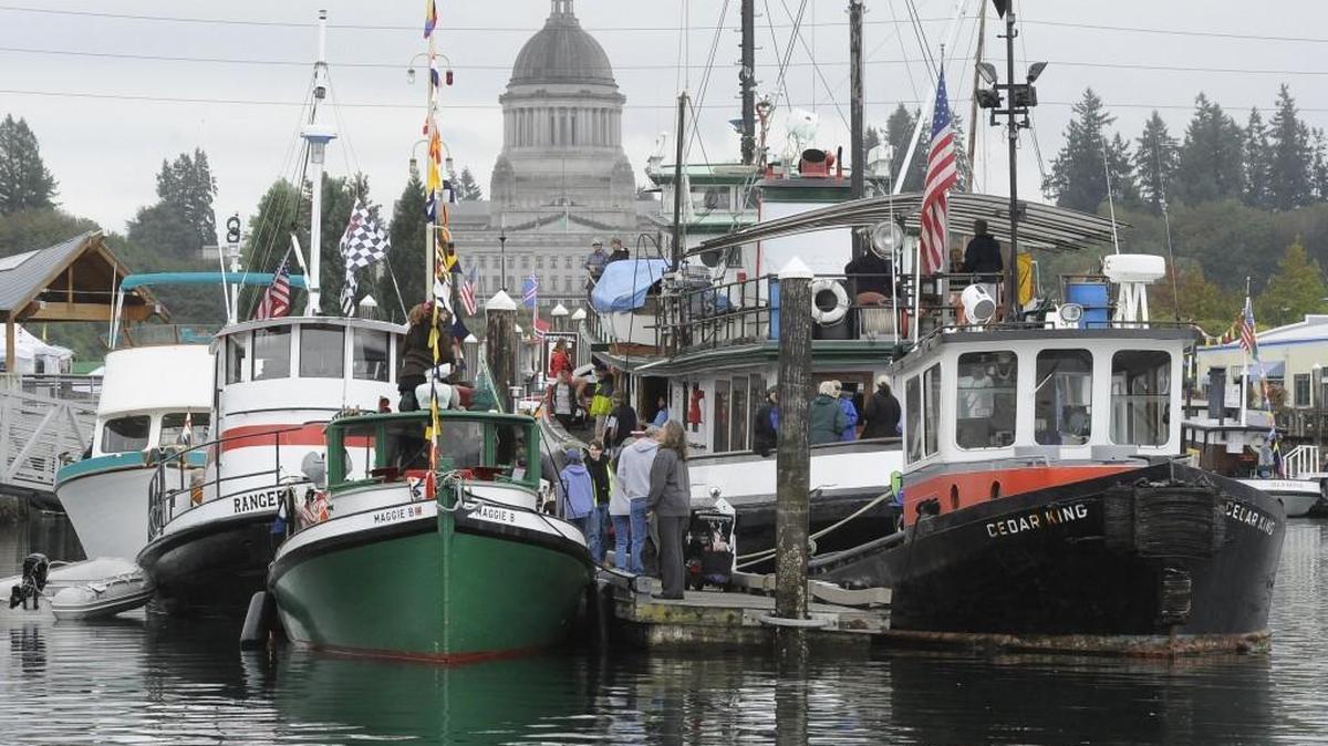 
Under a great sky canopy, visitors tour the fleet of tugs before they leave Percival Landing and out to the Budd Inlet race course for the 2015 Harbor Days Maritime Festival and Tugboat Races Sunday along the Olympia waterfront.
