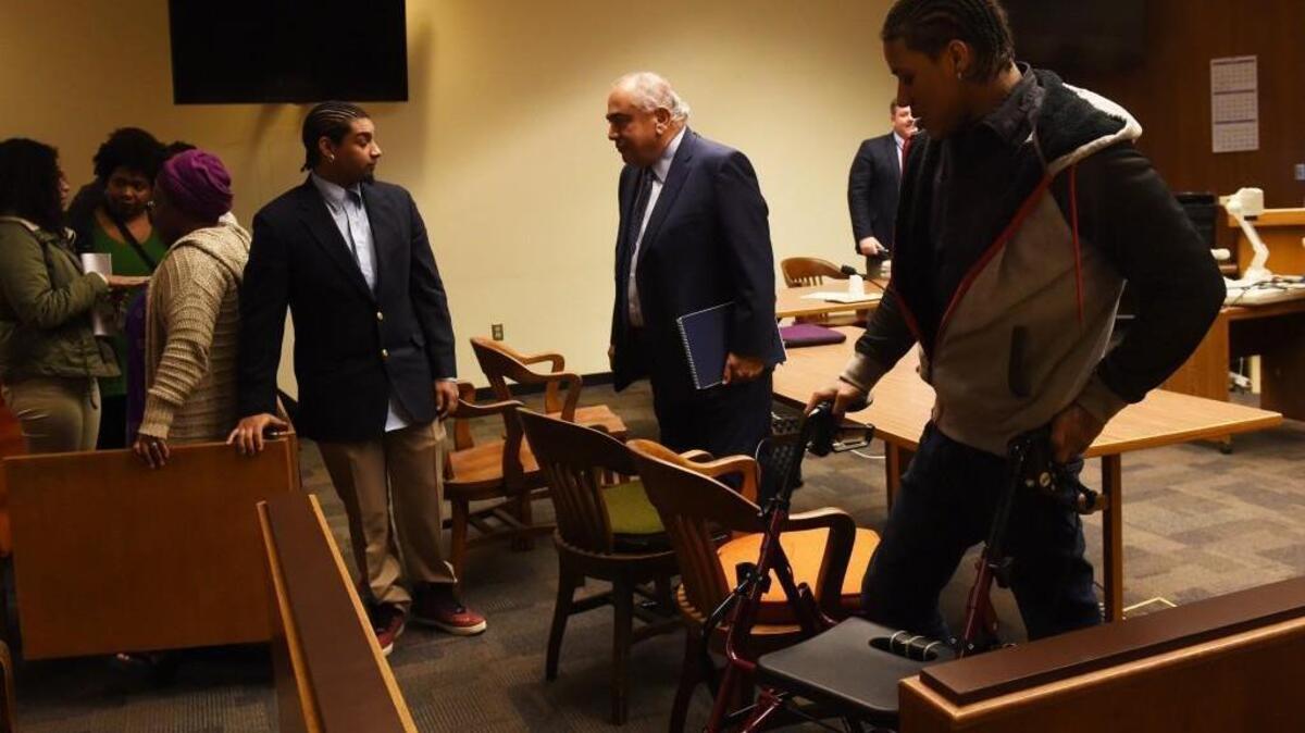 Flanked by defendants Andre Thompson, left, and Bryson Chaplin defense counsel George Trejo and Sunni Ko (not pictured) leave the chambers after a Feb. 22 hearing before Thurston County Superior Court Judge Erik Price.