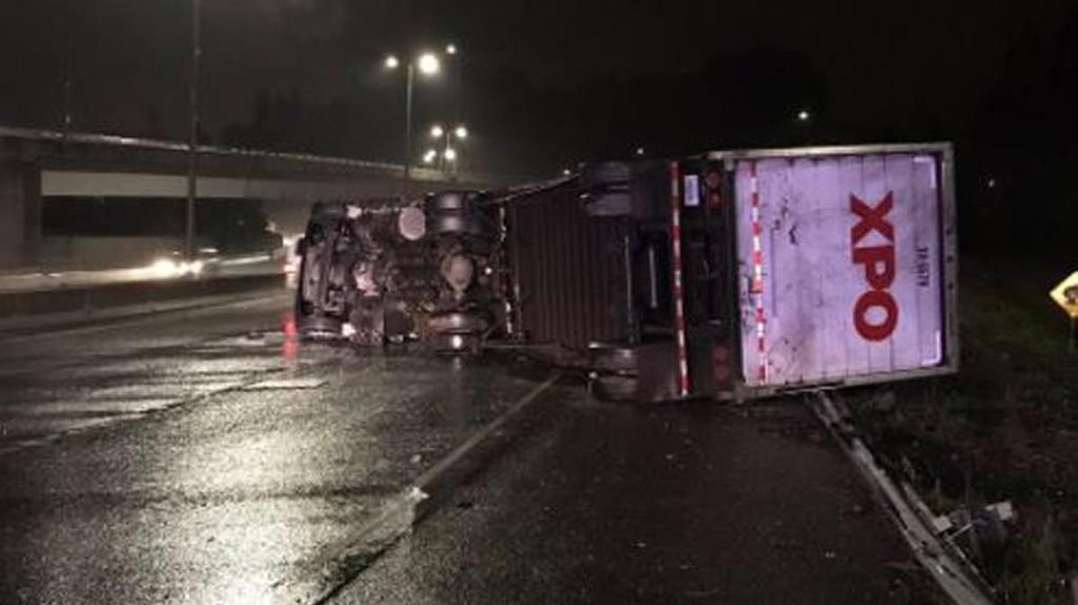 A tractor-trailer that rolled over blocks traffic on Interstate 5 in Olympia.
