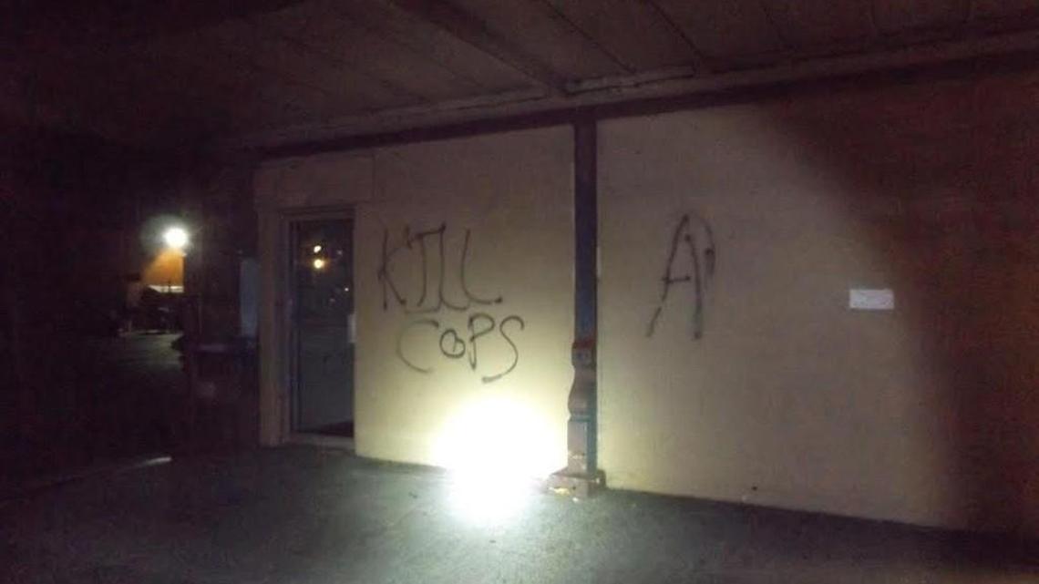 A group of about 30 people passed through downtown Olympia Sunday night, Aug. 14, 2016 and left anti-police messages on multiple buildings and structures, including city hall.