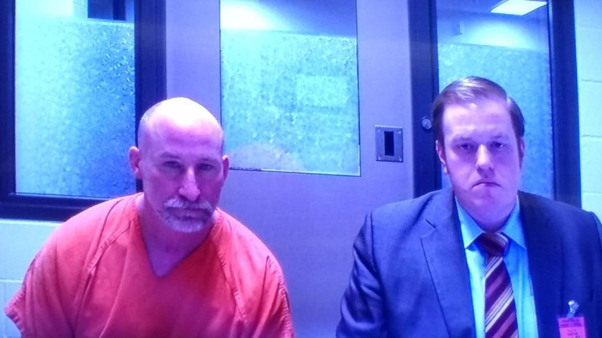 Douglas H. Cook (left) is accused of ramming a van containing five people, west of Tenino. He appeared Wednesday afternoon in Thurston County Superior Court with Public Defender Luke Swinney.