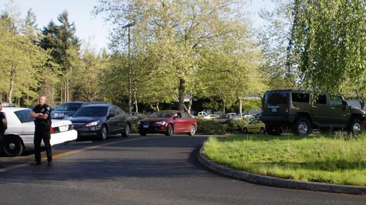 Police guard the entrance to North Thurston High School on April 17, after a student fired two shots from his father’s .357 Magnum before being tackled by a teacher. He had been a student at the school only 19 days.