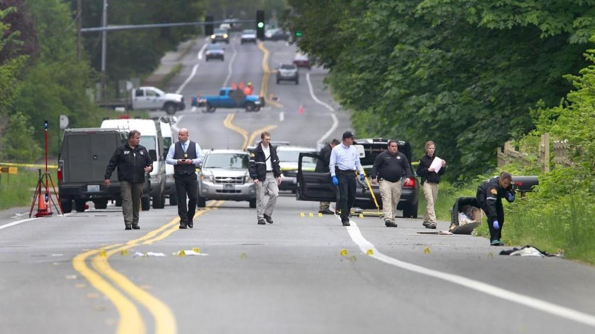 
Investigators comb the scene of an officer-involved shooting May 21 on Cooper Point Road after two men who were suspected of stealing from the west Olympia Safeway, and were later shot by an Olympia police officer.
