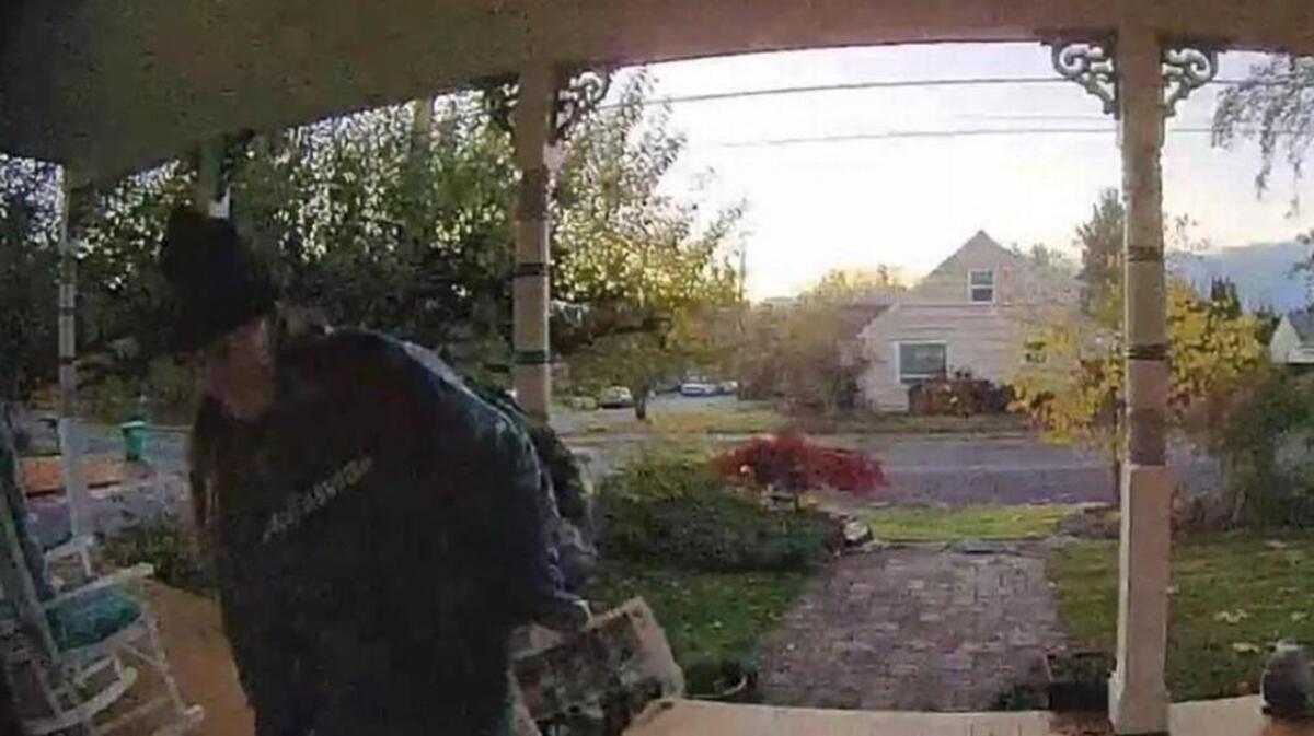 A home surveillance camera records someone taking packages off the porch of a home on Boundary Street Southeast in Olympia last year. Thurston County Sheriff’s Office wants to know which homes have surveillance cameras that could be used in investigations.