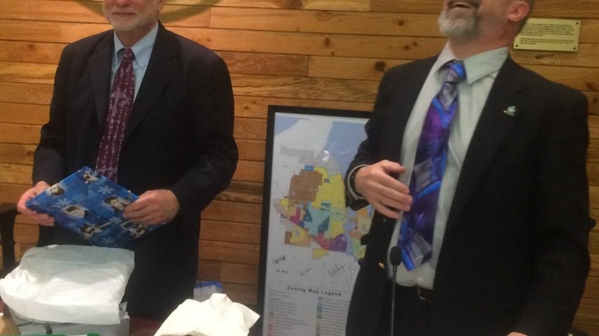 Mayor Stephen Buxbaum, left, and Councilman Steve Langer share a laugh Dec. 15 at their final Olympia City Council meeting. Both declined to seek re-election.