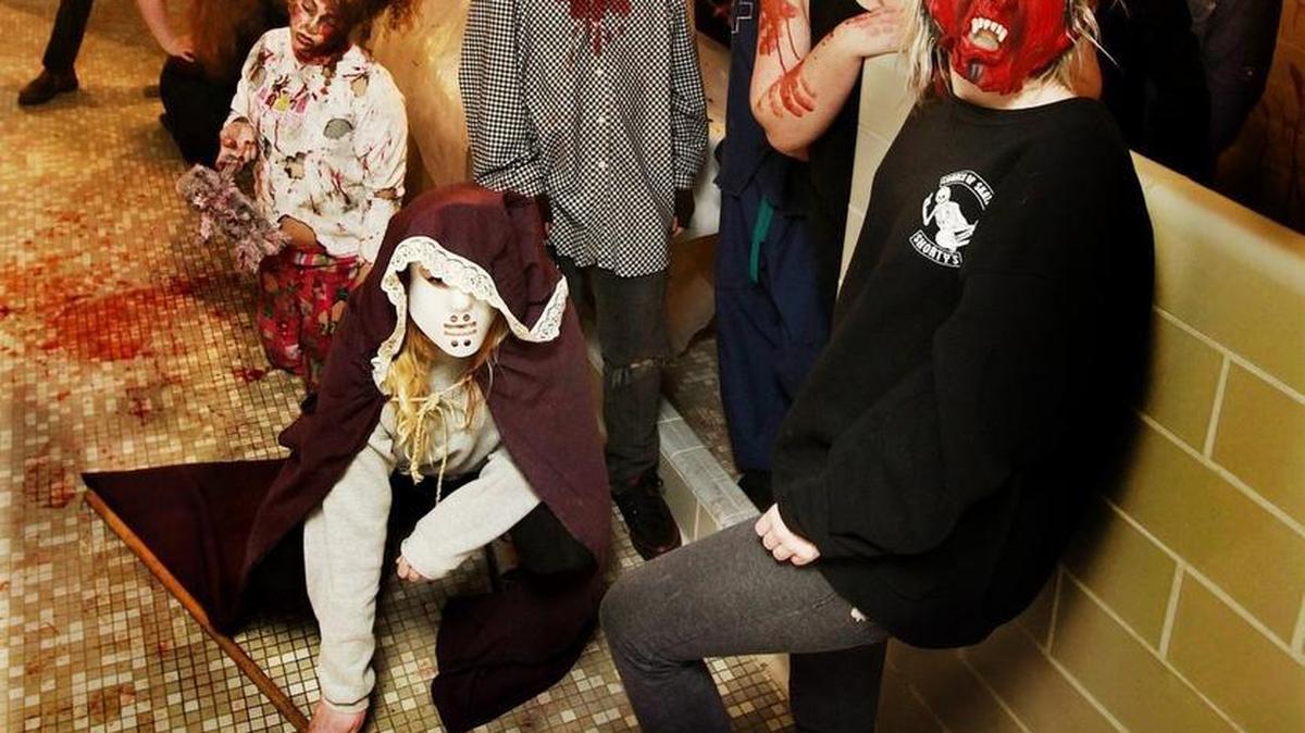 Students at Avanti High School in Olympia roll out in costume as goblins and ghouls Tuesday evening while terrorizing the halls of their Haunted School.