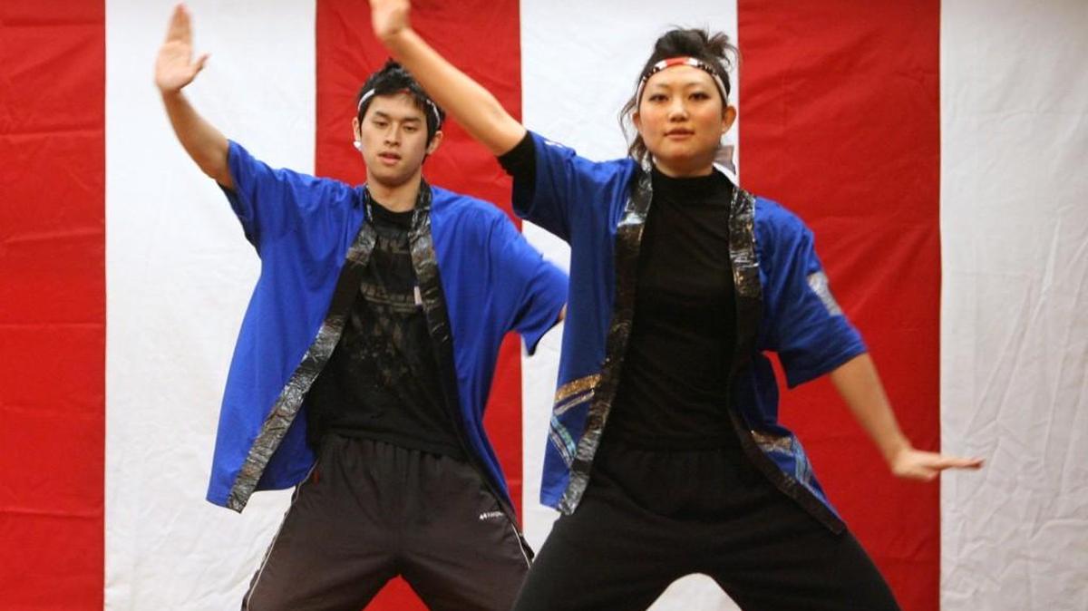 Saint Martin's University students Mashashi Yamada (left) of Nagano, Japan, and Aki Kodama of Kobe, Japan, perform the Soran Bushi dance with the Yasukoi Dancers on the main stage at the Oshogatsu Japanese festival in the Olympia Center on Jan. 29, 2011. (Tony Overman/Staff Photographer)