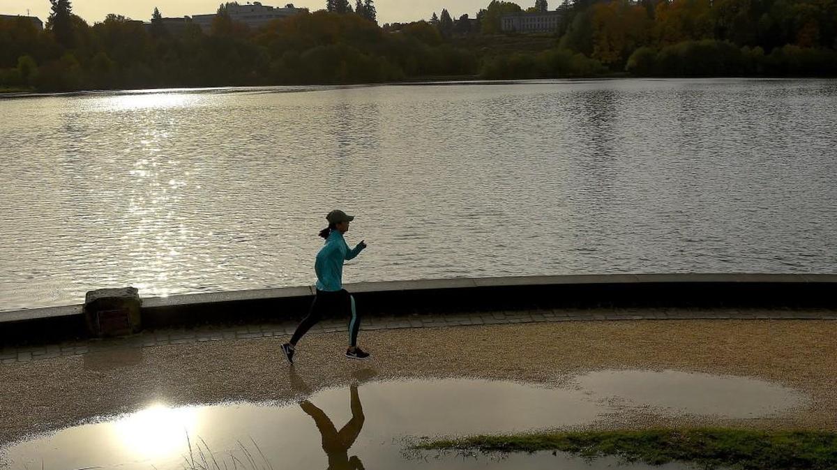 A jogger along Olympia's Capitol Lake enjoys a glint of Sunday morning sunshine after a vigorous rainstorm battered the region most of Saturday. With some showers still persisting for the day a welcome drying pattern is forecasted for the upcoming week.