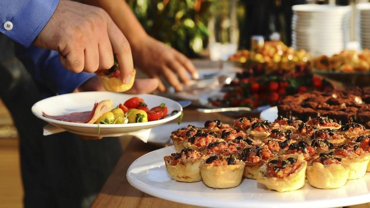Holiday stress can lead to overeating and weight gain. One tip for keeping your snacking down at parties: Don’t linger by the food table.