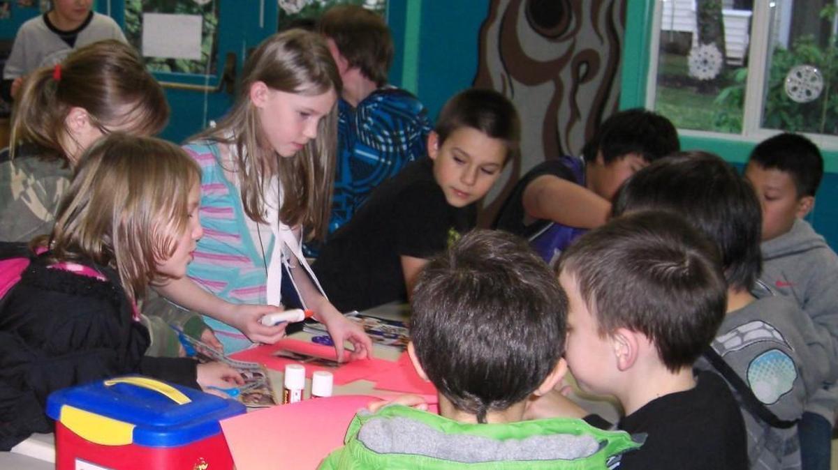 Children participate in making collages at the Evergreen Villages community center on Olympia’s west side. The center, which was operated by the nonprofit group Together, closed Monday.