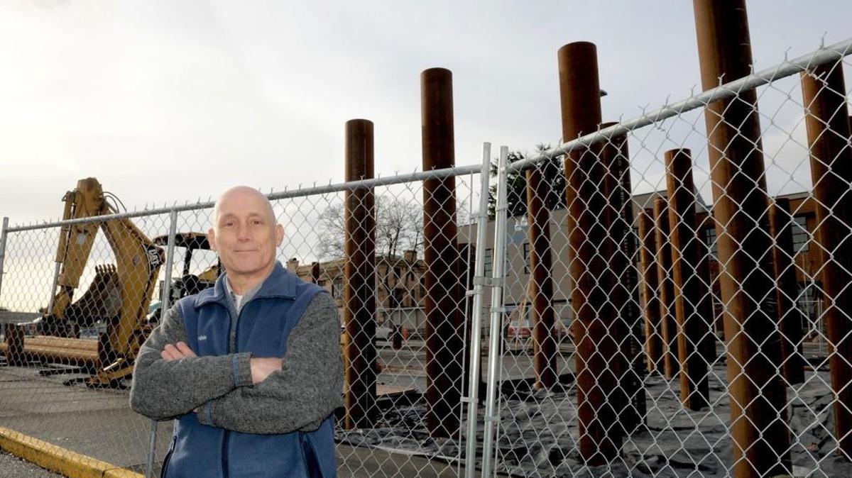 Standing by the 321 Lofts apartment project at the corner of Legion Way and Franklin Street on Dec. 16, longtime community volunteer Roger Horn is stepping down from the Olympia Planning Commission after more than a decade of service.
