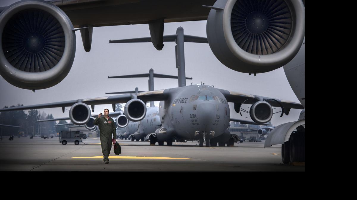 
FILE PHOTO: Lt. Colonel Nathan Campbell checks over a C-17 with his flashlight at the airfield of JBLM in January. The C-17 was among the aircraft involved in a late-night training exercise July 26, 2015, that startled some residents in Thurston County.
