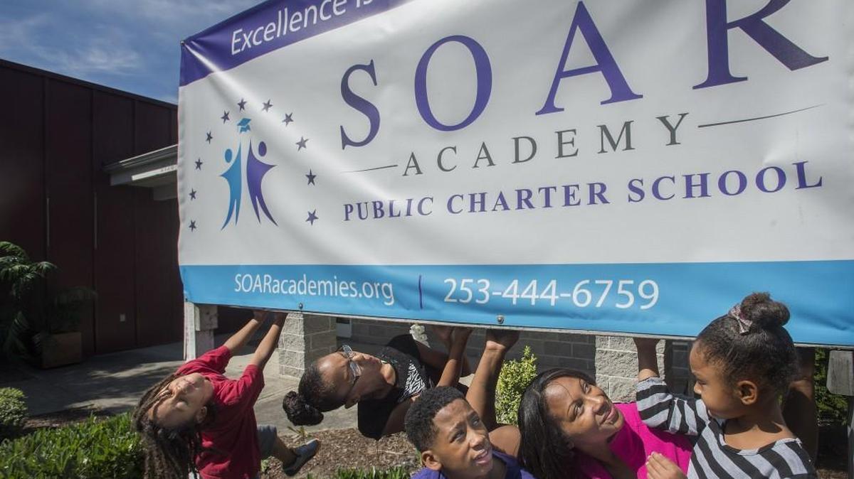 
Roquesia Williams with her children, Gesiah, 6, l-r, Gehariii, 11, Genai, 14, and Gervais, 4, at SOAR Academy in Tacoma on Tuesday, July 14, 2015. Williams is a triple pioneer, she will have a child at each of Tacoma's three new charter schools opening this year.
