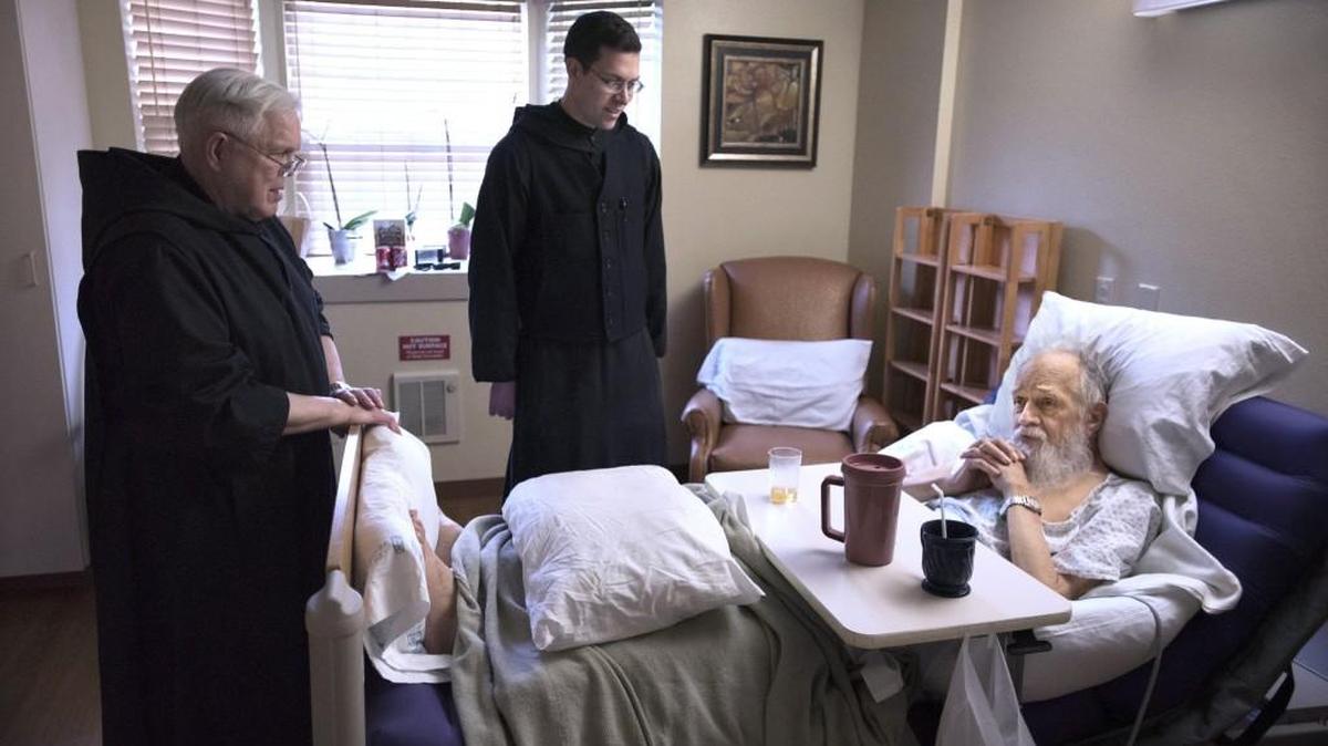 Father Benedict Auer, left, and Brother Mark Bonneville visit with Father Alfred Hulscher in hospice care at the Mother Joseph Care Center in Olympia on Saturday.