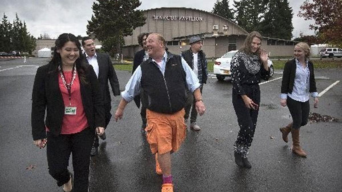 Star chefs from the television show “The CHEW” walk with Saint Martin’s event staff as they head to a meet & greet session with students at Saint Martin’s University in Lacey on Saturday, Nov. 7, 2015. The chefs were on campus for the university’s 10th annual Saint Martin's Gala, a black-tie fundraiser for student scholarships.