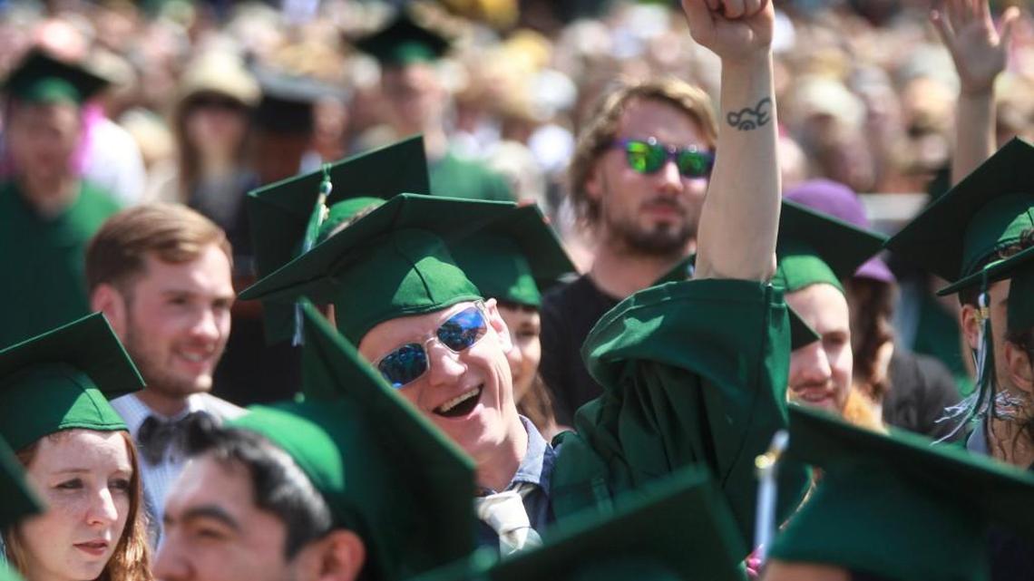 Graduate Michael Hunecke of Saint Charles, Illinois, cheers during the 2014 commencement ceremonies at The Evergreen State College in Olympia. This spring’s commencement ceremony is being moved to Cheney Stadium in Tacoma because of safety concerns.