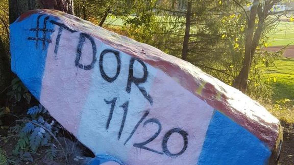 A group of students and parents repainted Capital High School’s spirit rock on Monday after the group’s earlier message about Transgender Day of Remembrance was vandalized.