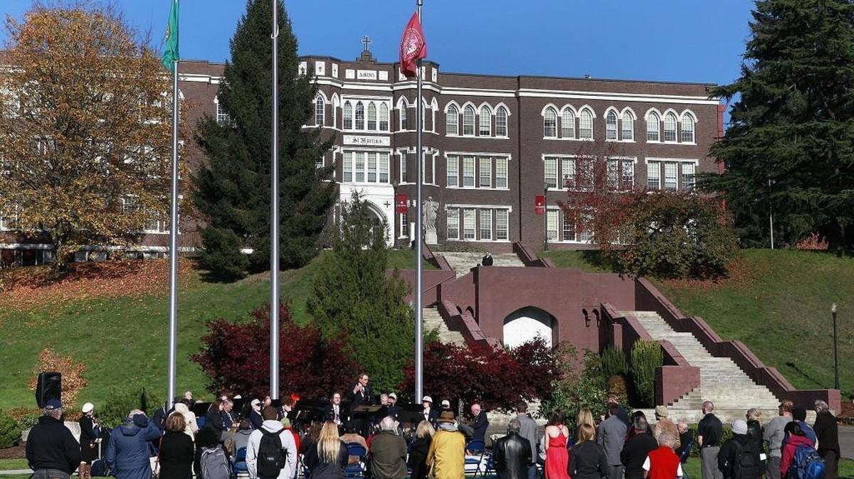 FILE PHOTO: A ceremony at Saint Martin’s flag pavilion in 2014. Non-tenured faculty at the private university voted in June to form a union, and the administration is fighting that effort. Faculty and students are planning to participate in a walkout scheduled for 1 p.m. Tuesday over the matter.
