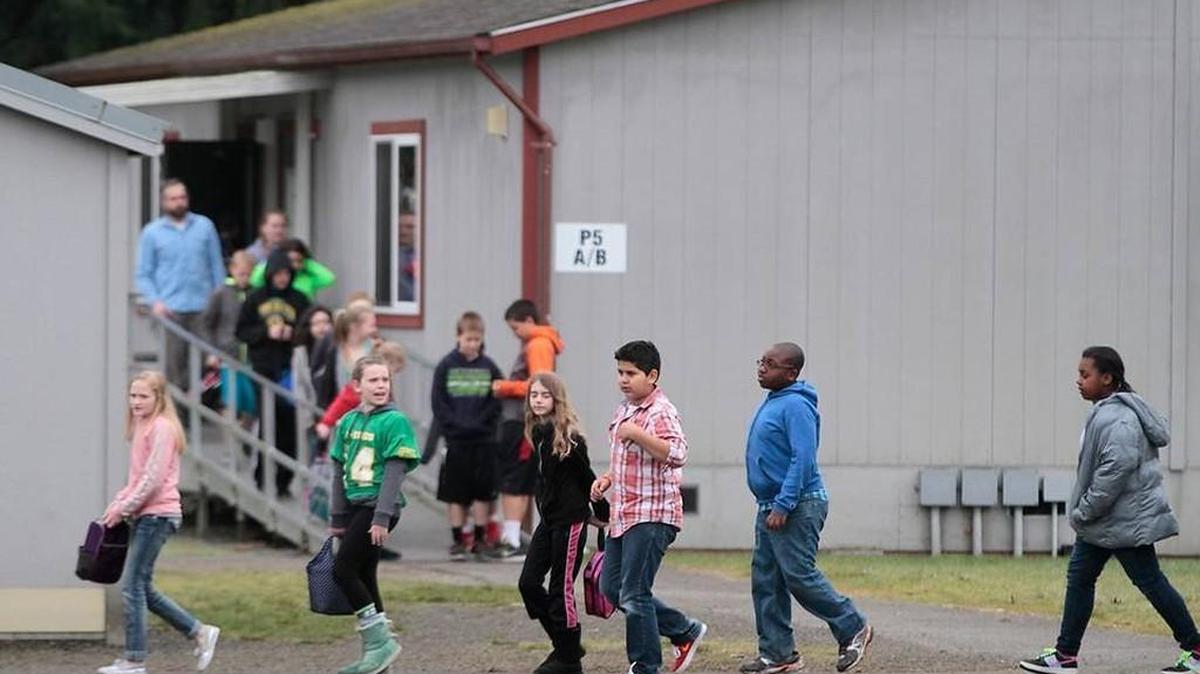 Olympian file photo: Students move from the portable buildings to the cafeteria at Peter G. Schmidt Elementary in Tumwater on Tuesday, Feb. 10, 2015. The school has no indoor hallways, which assistant principal Keith Rhodes says creates a security concern. Officials will talk about the district’s upcoming levy, as well as provide an update on 2014 bond projects, during a Community Roundtable on Thursday.
