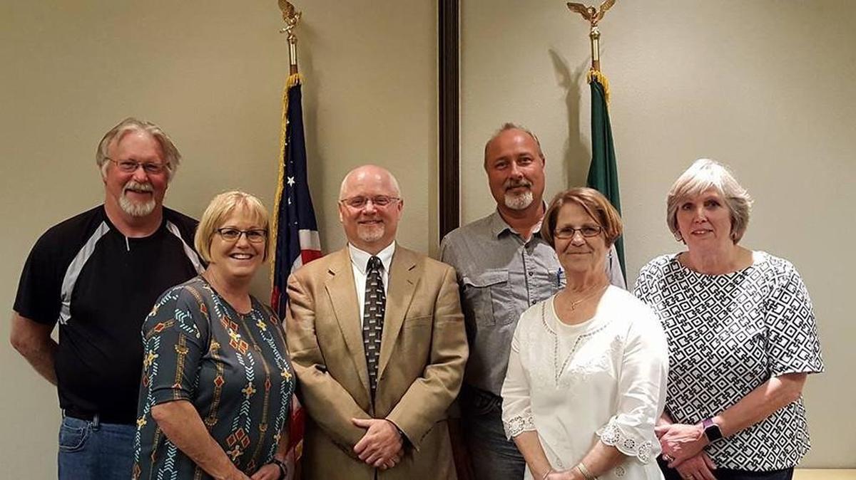 Yelm High principal Brian Wharton (third from left) stands with Yelm School Board members after accepting their offer to become the district’s next superintendent on Thursday night.