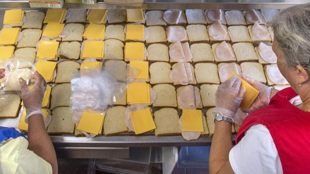 Staff file: Susan Lenox (left) and Denise Jorgenson assemble dozens of turkey and cheese sandwiches as they prepare sack lunches in the kitchen at Garfield Elementary School in Olympia on Wednesday, June 24, 2015. The Olympia, Tumwater and North Thurston school districts could benefit from an online campaign to pay off lunch debt in Washington’s schools.