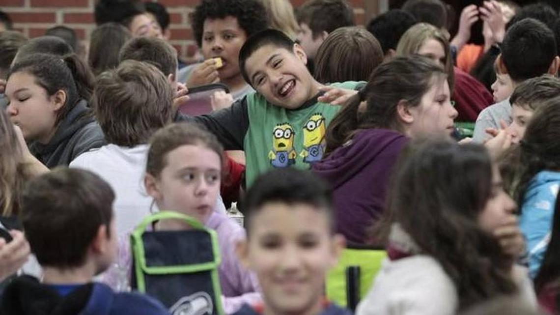 Sixth-grader Sebastian Friastriana laughs with friends in the packed cafeteria during lunch at Peter G. Schmidt Elementary in Tumwater on Feb. 10, 2015. The Tumwater School District had the worst attendance record in Thurston County, according to state data released Tuesday.