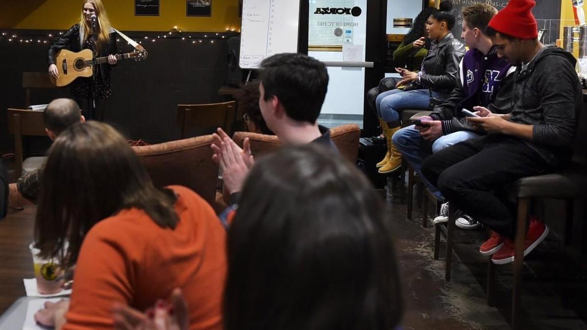After reciting several of her poems and performing a song North Thurston High School senior Emily Dahlgren receives applause from the audience during a Lacey Loves to Read Open Mic Night held at the Marvin Road Forza Coffee shop on Feb. 10th. The monthlong literacy celebration’s featured writer Kwame Alexander will participate in a Feb. 18 reception at the Lacey Community Center.