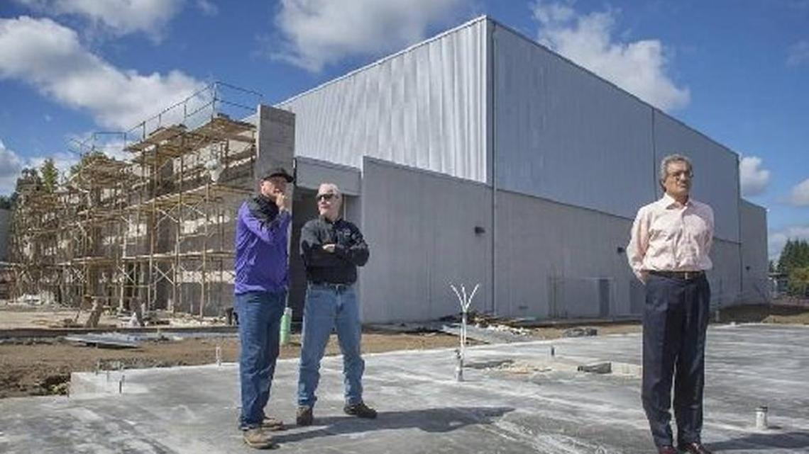 Alan Bowen (from left), superintendent for Forma Construction, North Thurston assistant principal Dan Coleman and district superintendent Raj Manhas tour the new gymnasium construction, part of a two-phase, $40 million construction and remodeling project at North Thurston High School in September. Manhas announced Tuesday he will retire at the end of the school year.