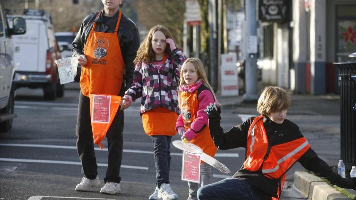 The Kelley family of Olympia takes to the streets to help raise money for the annual Mixx-96 Holiday Toy and Fund Drive in downtown Olympia in 2012.