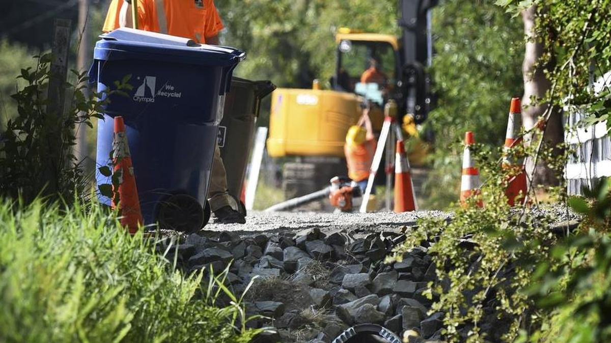 
City of Olympia stormwater crews stand by a finished culvert replacement as crews continue south down Wiggins Road in Olympia on Wednesday.
