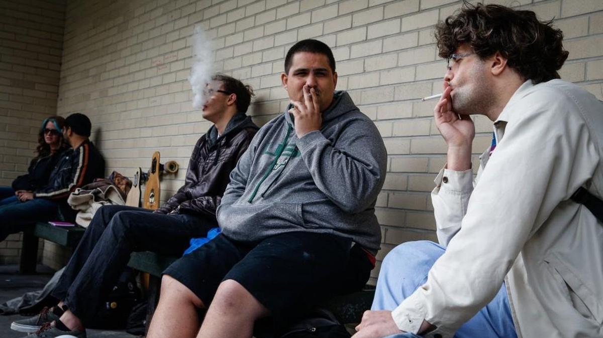 University of South Florida students, from right,Tristan Lear, Joshua Kessel and Leo Nunez smoke together outside the USF Tampa Campus Library in Tampa, Fla., on Wednesday, Jan. 13, 2016.